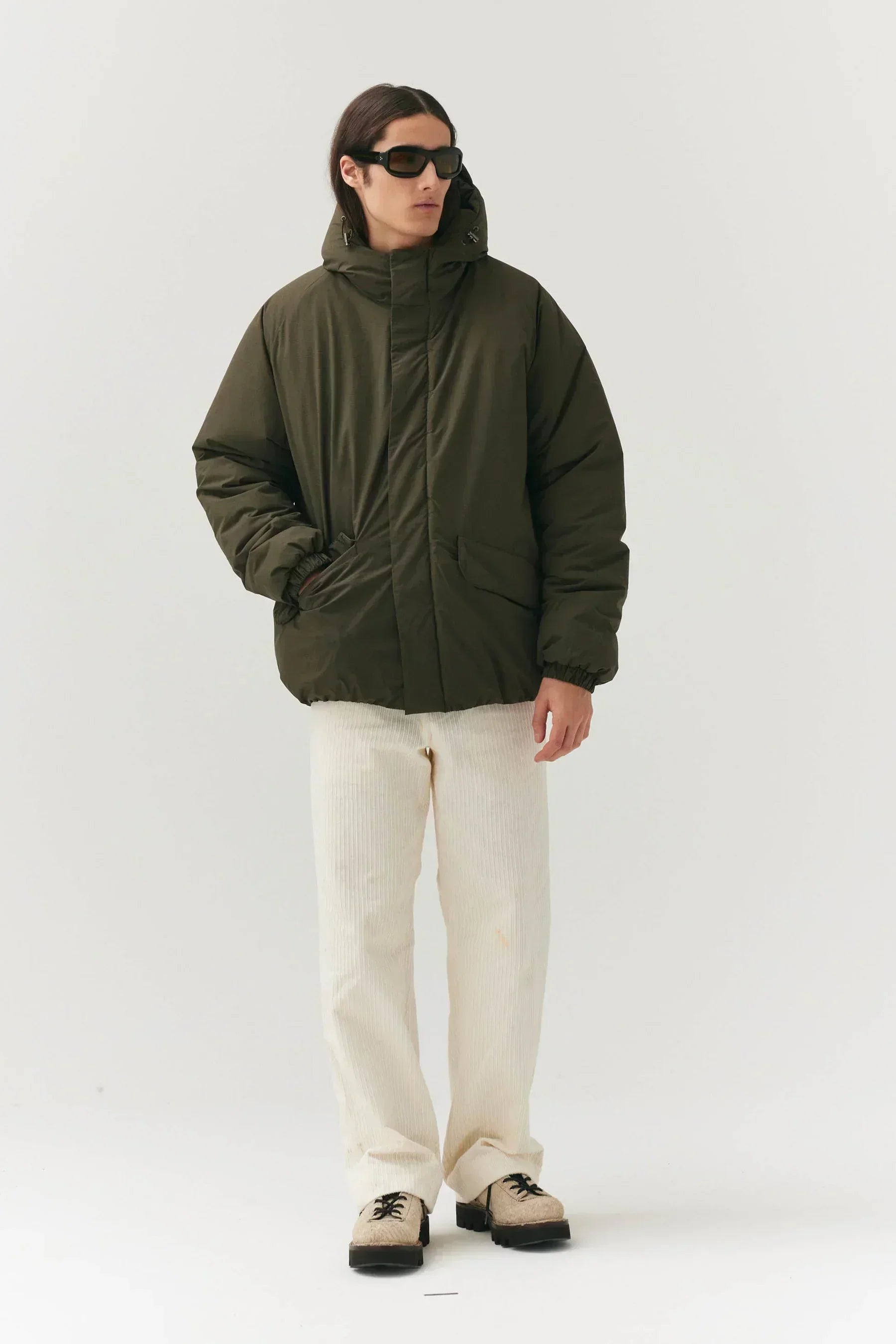 K-SEA New Army Jacket by Prestige Market, olive green military-style jacket with front pockets and adjustable sleeves.